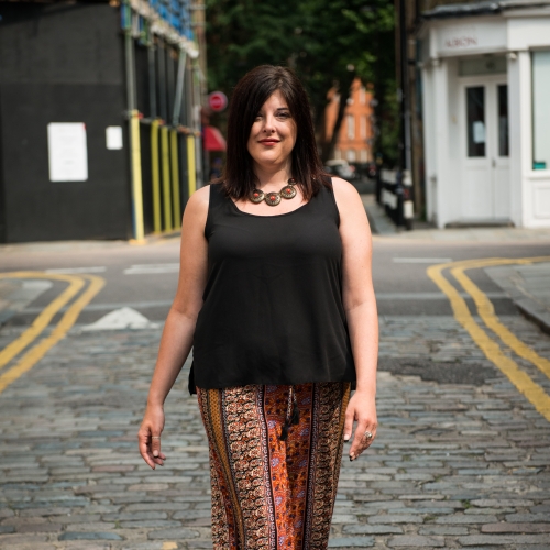 Claire walking towards the camera on a cobbled road