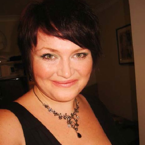 Katherine Nickoll smiling for the camera in a black dress