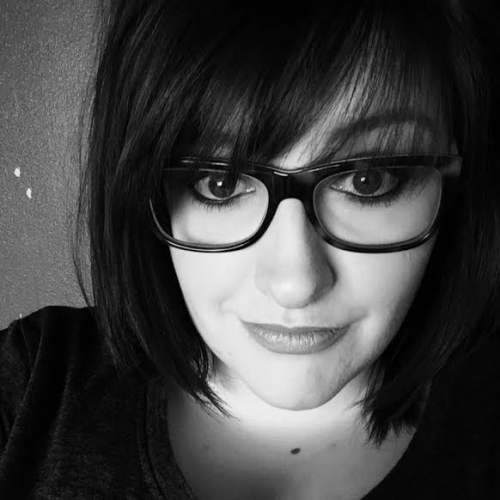 Sarah Alexander in black and white wearing glasses