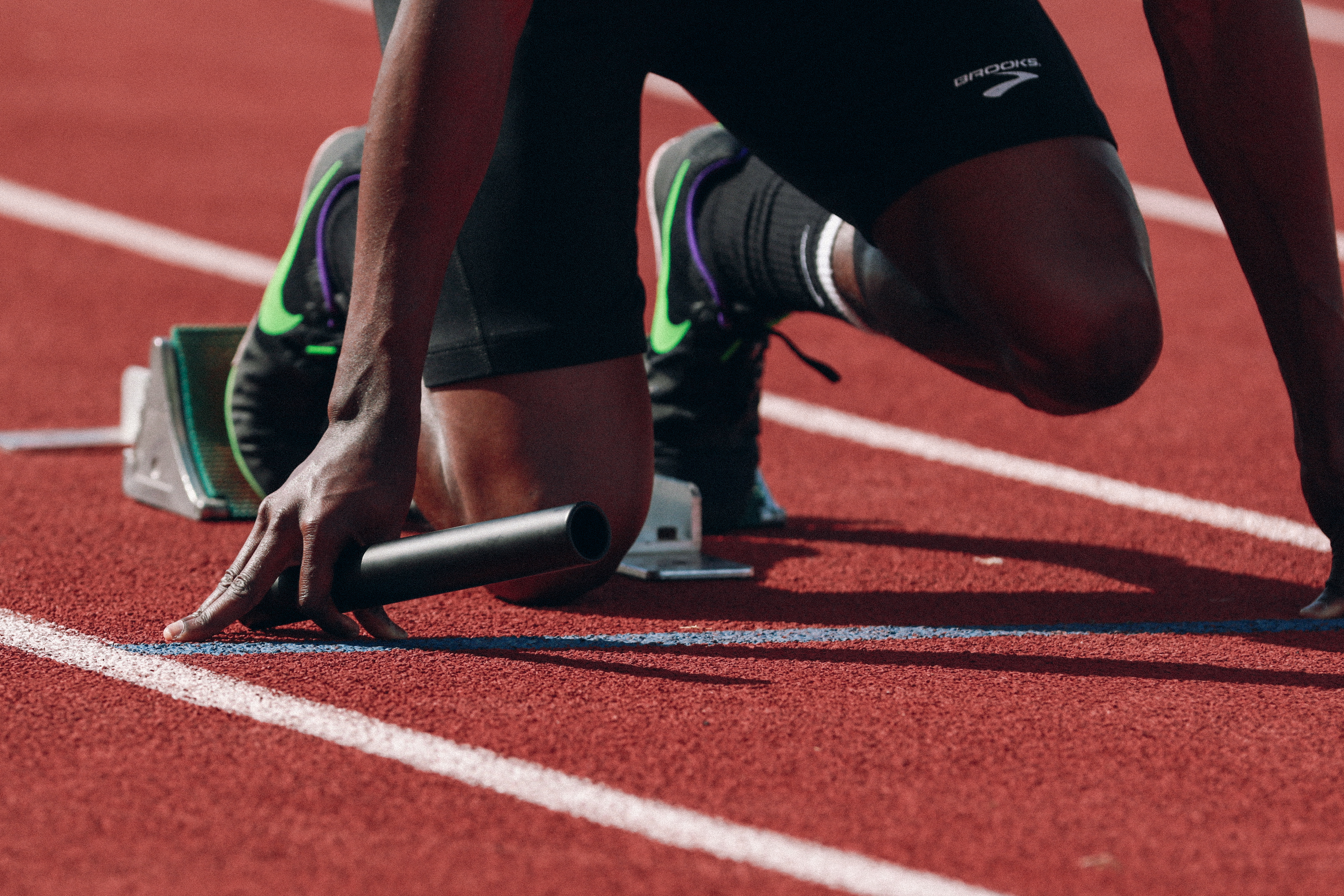 sprinter taking position at the starting blocks