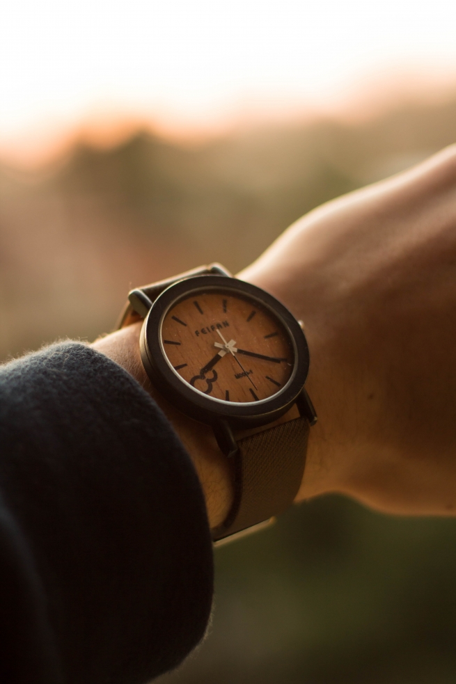 a woman wearing a brown watch